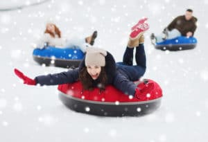 people tubing on skiing slopes