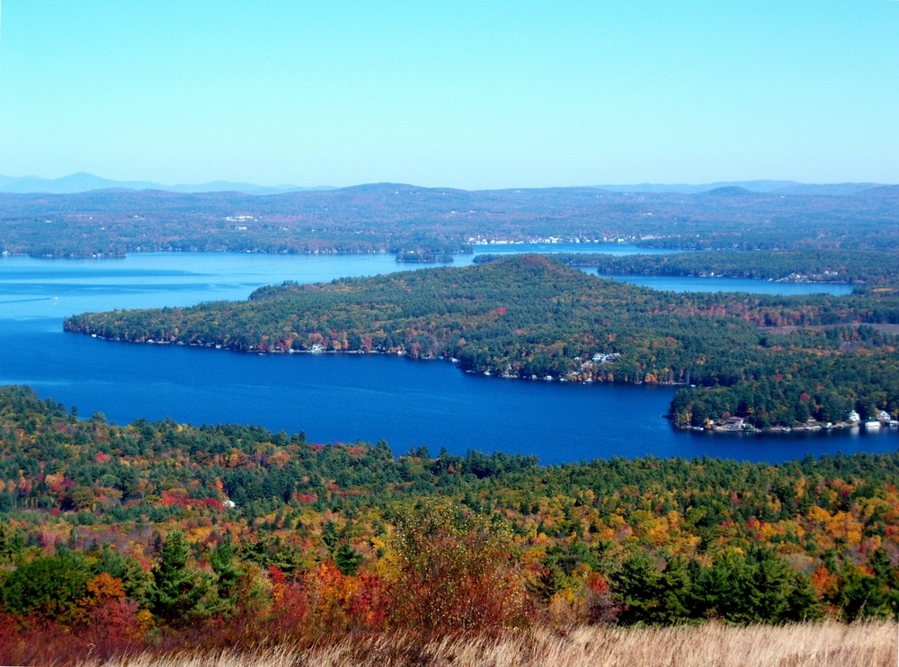 The Winnipesaukee Scenic Railroad is just one of the things to do in the Lakes Region This fall - enjoy this scenic view from the surrounding peaks of the lakes