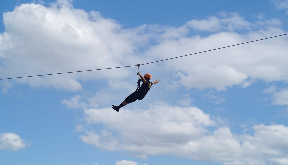 man ziplining at places like Gunstock Mountain Resort in New Hampshire